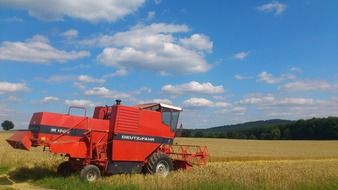 red combine harvester on the field