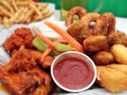 onion rings, chicken wings and sauce