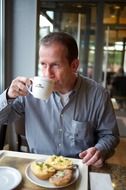 man drinking coffee for breakfast