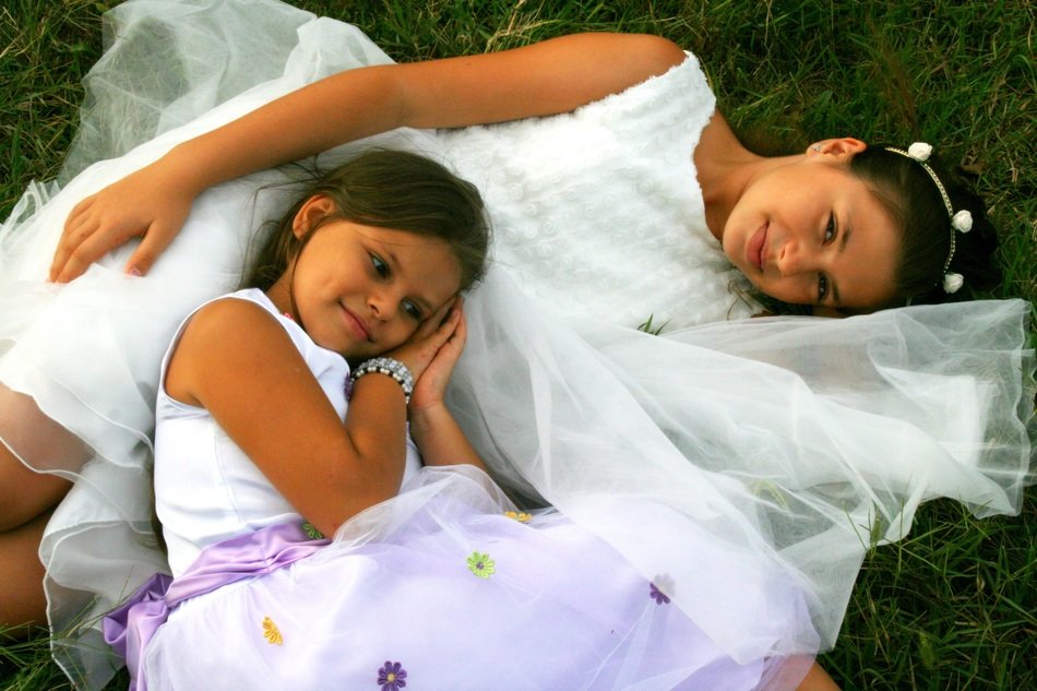 Happy sisters in white dresses