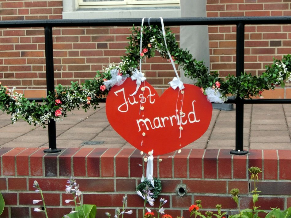 wedding inscription with a garland on the fence