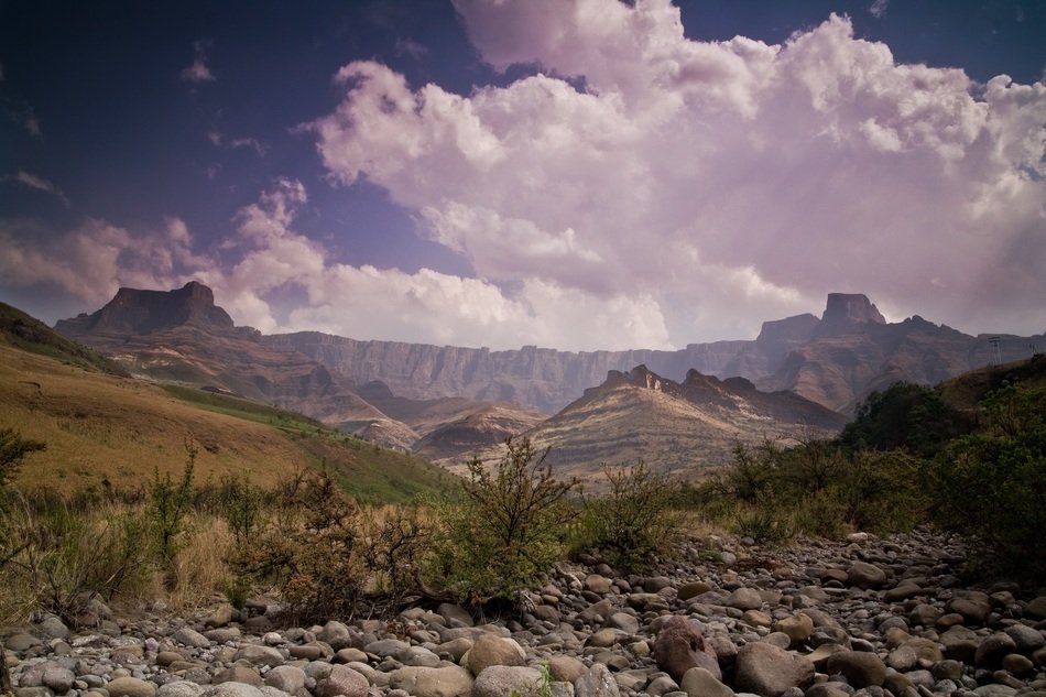 landscape of mountains with large puffy clouds