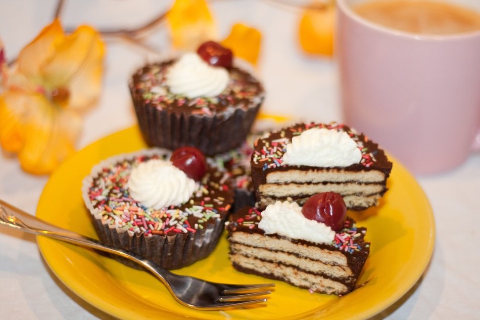 pastries with cream and berries on a yellow saucer