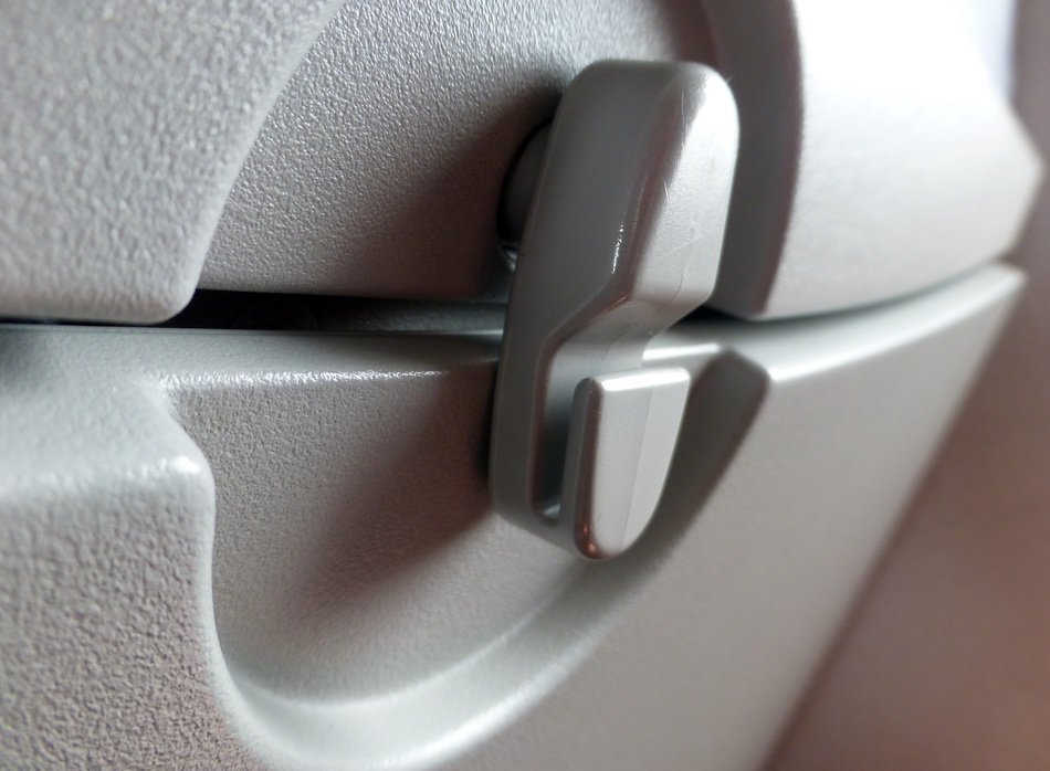 lock handle on the back of an airplane seat