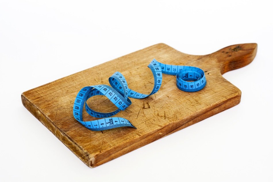 centimeter tape on a wooden board