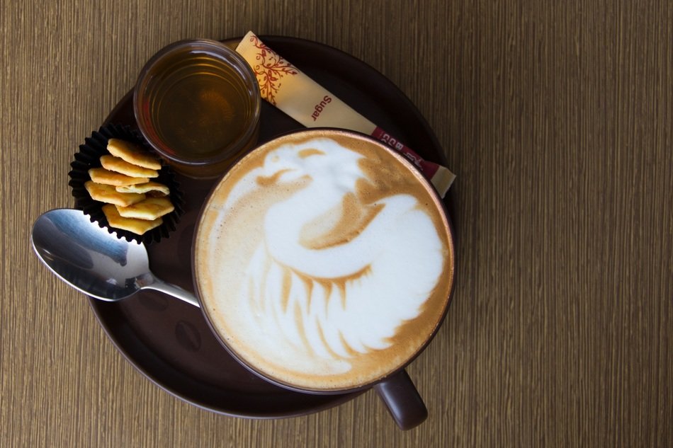 Beautiful drawn dragon on the foam of the coffee