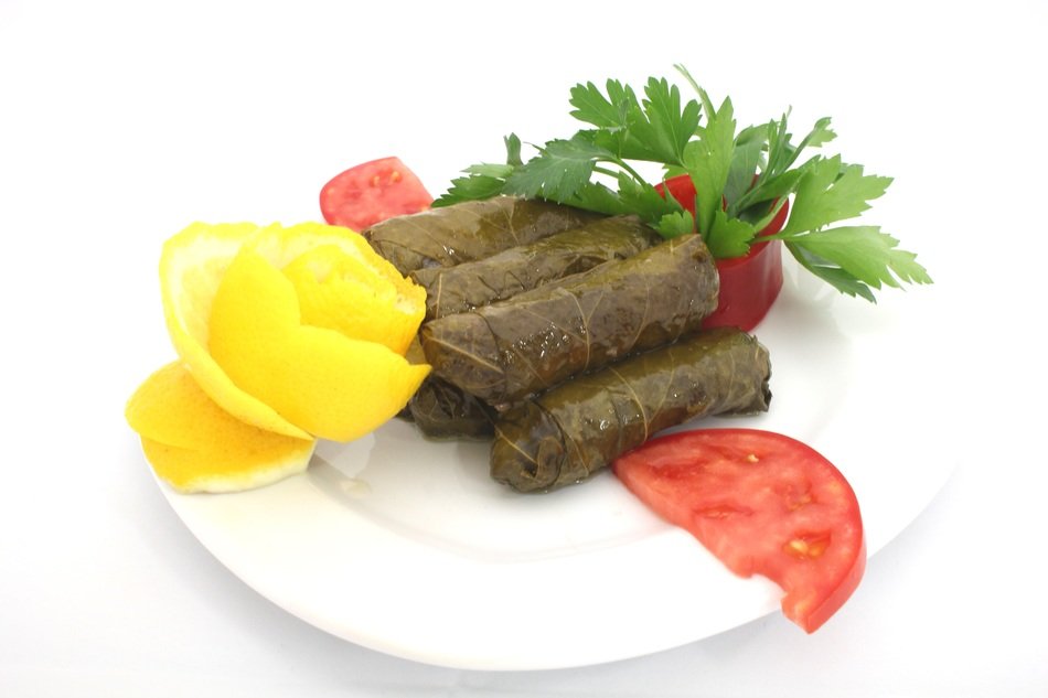 dish in grape leaves on a white plate