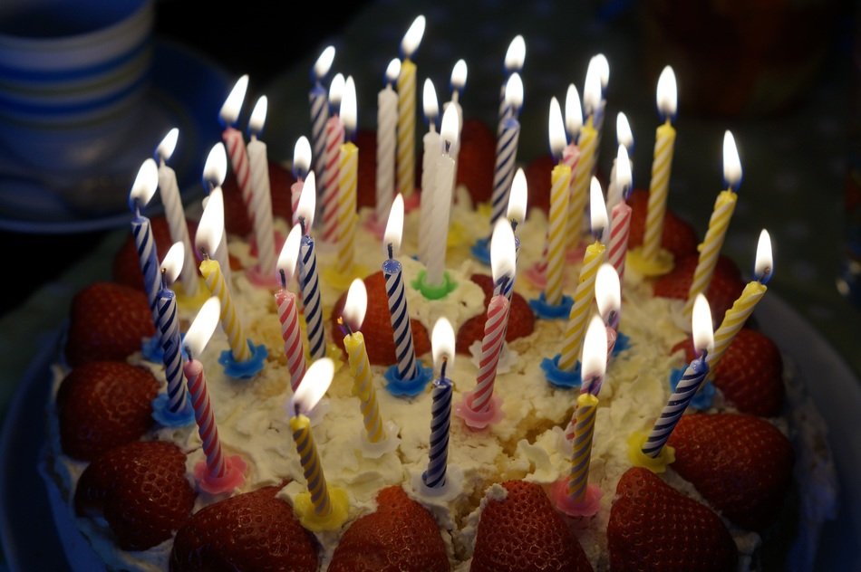 birthday cake with candles and stawberries