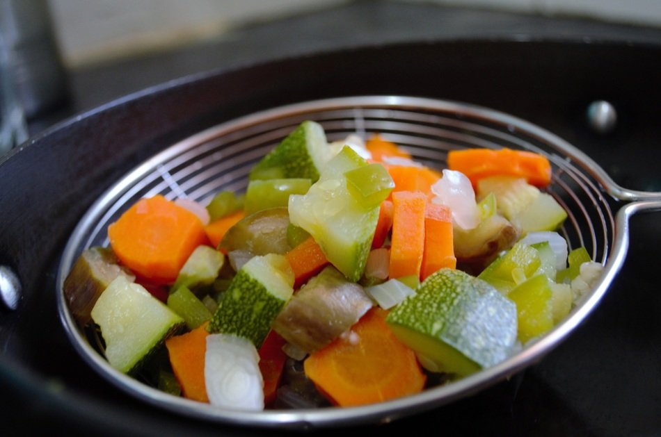 blanched vegetables in a sieve
