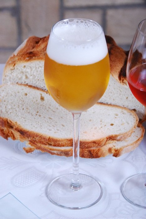 glass of beer on a background of bread