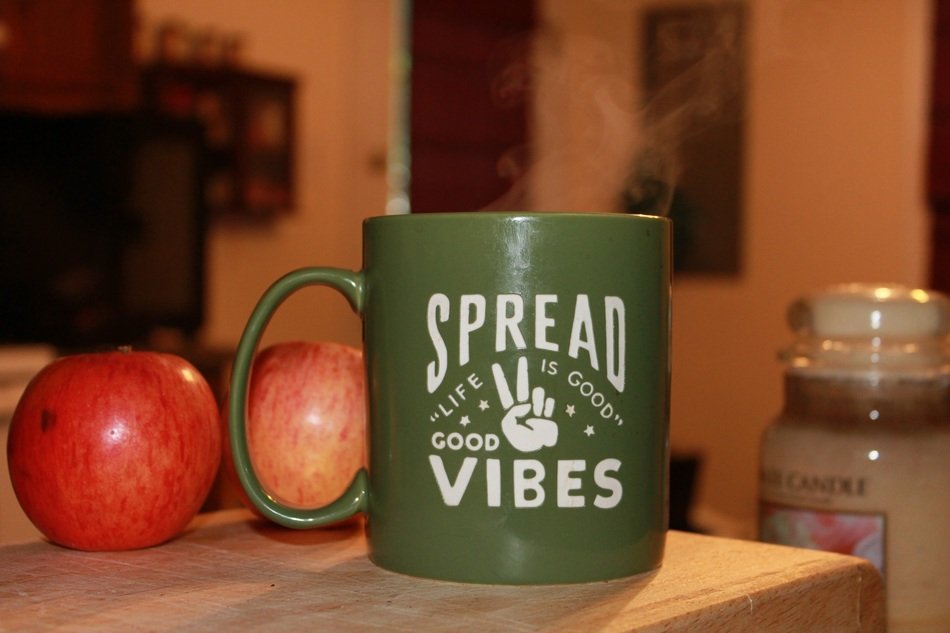 green cup with an inscription on the table