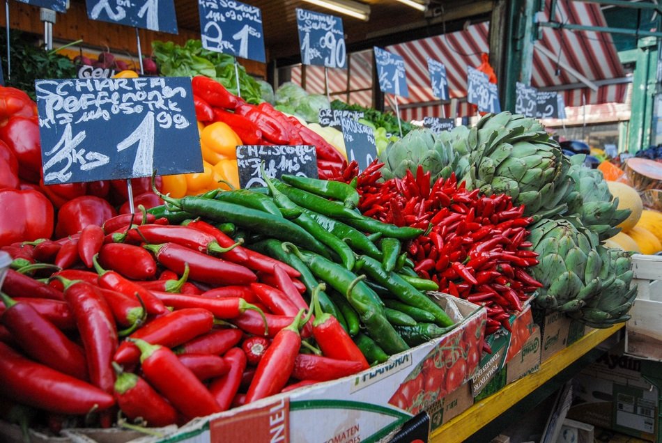 different peppers and other food on market stall