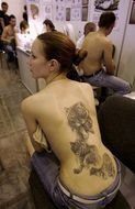 photo of a girl with a tattoo on her back