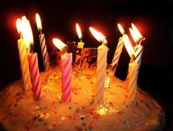 top of Birthday Cake With burning Candles at darkness