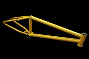 yellow bicycle frame on black
