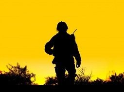 silhouette of a Vietnamese soldier on a background of yellow sunset