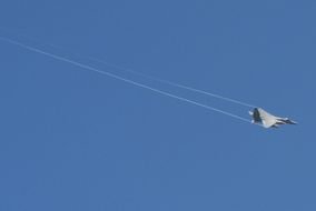 white stripes in the blue sky from a fighter