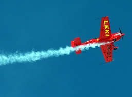 red plane flies in the sky