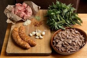 minced meat, sausages spices and herbs on the table