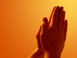 hands of a prayer on a light background