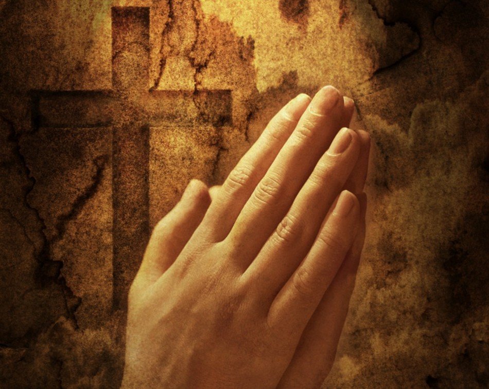 Praying Hands at grunge background with cross