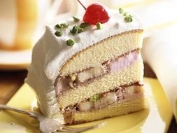 delicious piece of cake with banana pistachios and cherries