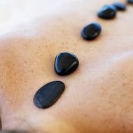 warm black stones on the back