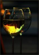 two glasses of white wine at sunset