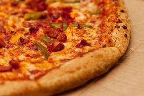 closeup photo of delicious pizza with crust in a cardboard box