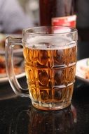 glass of light beer on a table in a cafe