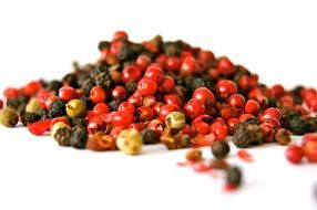 a small pile of dry red and black pepper