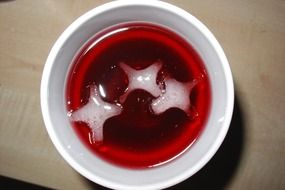 Ice cubes in a red soft drink