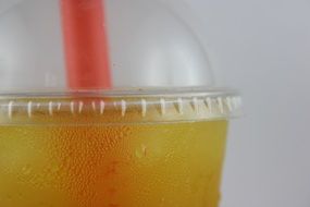 orange soft drink in a glass closeup