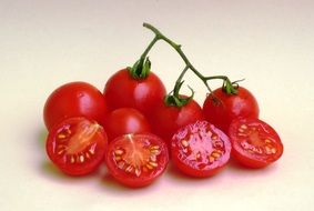 red tomatoes on the branch and sliced tomatoes