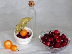 berries on a plate and an empty glass bottle
