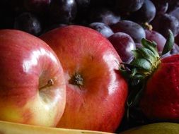 bowl with healthy fresh fruit apples grape strawberry