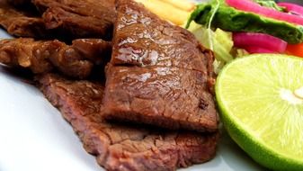 juicy beef steak and green lime