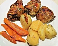 fried meat with potatoes and carrots