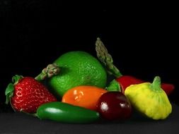 colorful fruits and vegetables at dark background