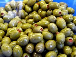 many stuffed olives with red pepper