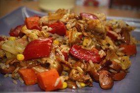 Rice ladle and sausages in a plate