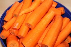 peeled carrots on a blue plate