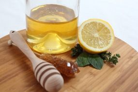 Citrus fruits and honey on a board