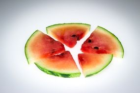 sliced watermelon on a white surface