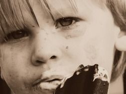 child boy eating ice cream, sepia