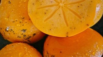 persimmons in water drops close-up