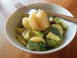 Potatoes with salad in the plate