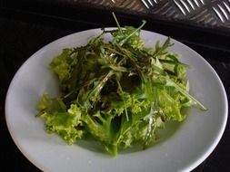 green salad for healthy eating on a white plate