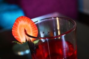 juice in a glass with strawberry close up