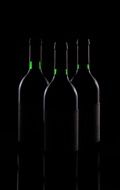 three wine bottles at darkness